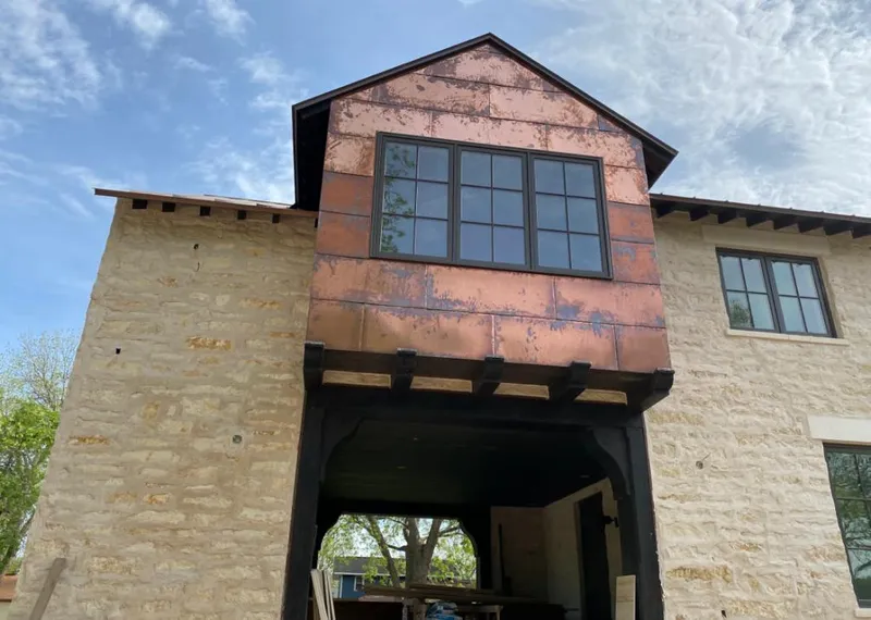 Copper metal panel facade on a stone building for Metal Roof Coating in Riverton