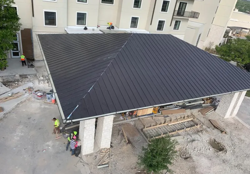 Metal roofing installation team working on a commercial building in Riverton